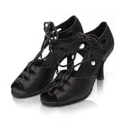 pair of black satin lace-up latin dance boots for women with cutout side panels, peep toe and a flared heel