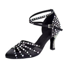 black satin closed-toe ballroom dance shoe with pearl and rhinestone sunburst toe design, crisscross strap