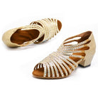 pair of gold glitter dance shoes for women with 1.5 inch cuban heel and caged rhinestone straps