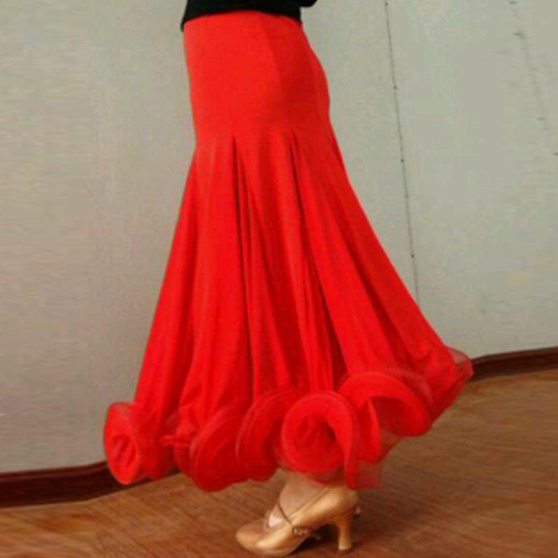Red ballroom dance skirt in motion showing flared godet hem and organza ruffle, side view