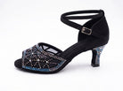 Black satin latin dance shoes side view, mesh vamp with an aurora borealis rhinestone starburst, crystal faced flared heel and crossed ankle strap