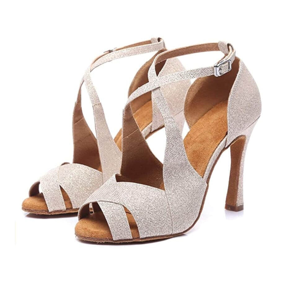 pair of nude glitter latin dance shoes for women with a wide crossover vamp, curved side cutout and stiletto heel