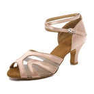nude satin latin dance shoe for women with curved mesh cutouts across the vamp, crossed ankle strap and a low flared heel