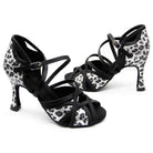 pair of leopard print latin dance shoes for women with black crossed toe straps, ankle strap and a flared heel