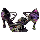 pair of black latin dance shoes for women in a multicolour feather print with patent crossed straps and a flared heel