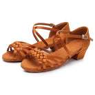 pair of tan satin latin dance shoes for women with a woven multi-strand vamp, crossed ankle strap and a low block heel