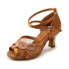 Tan satin salsa dance shoe for women, open toe latin heel with a rhinestone infinity knot on mesh, wrap ankle strap and rhinestone heel