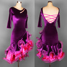 Purple velvet latin dance dress front view with slashed shoulder opening and pink ruffle hem
