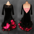 Black velvet latin dance dress with pink ribbon lacing across the open back