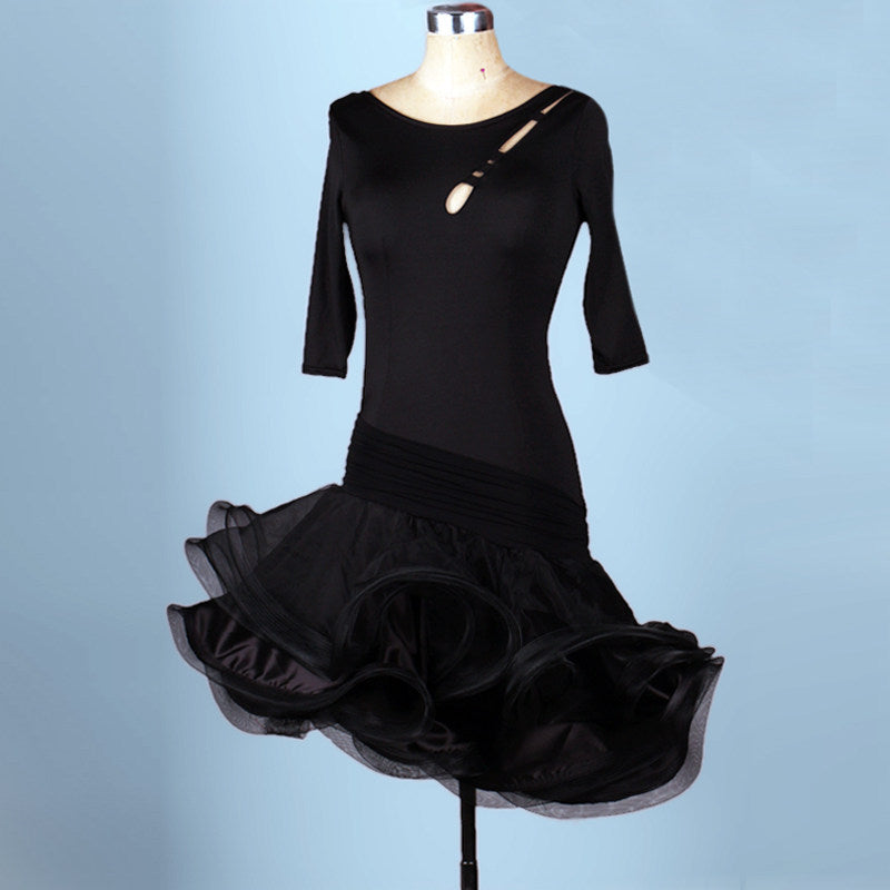 Black latin dance dress with elbow sleeves and ruched waist over a flared hem