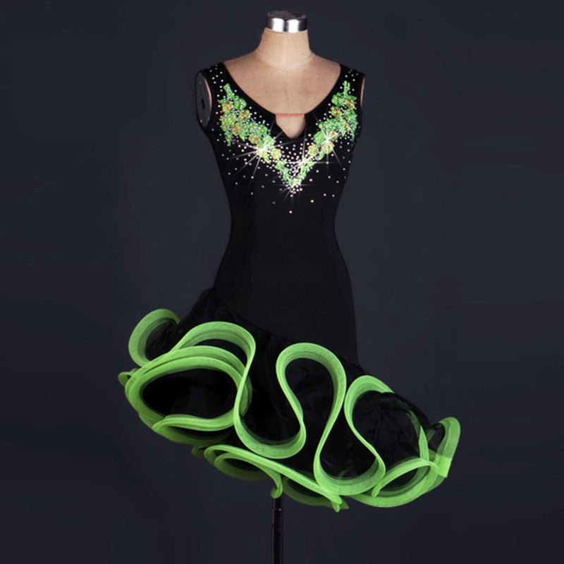 Black latin dance dress with green floral applique at the V neckline and green curled ruffle skirt