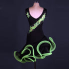 Black latin dance dress rear view showing the green applique tracing over the shoulder and open back