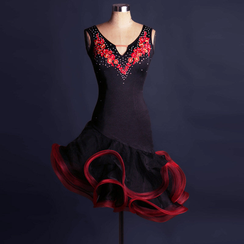 Black latin dance dress with red floral applique and red curled organza ruffle skirt