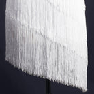 Close view of the white tassel fringe tiers on the latin dance dress hem