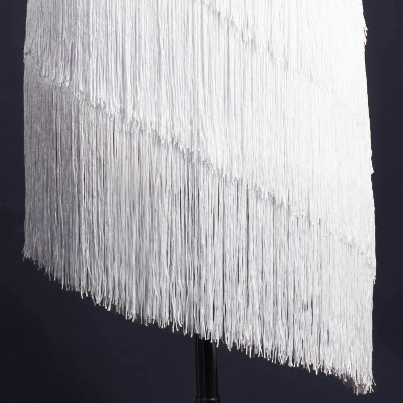 Close view of the white tassel fringe tiers on the latin dance dress hem