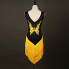 Black latin dance dress showing the gold appliques and rhinestones across the V neckline