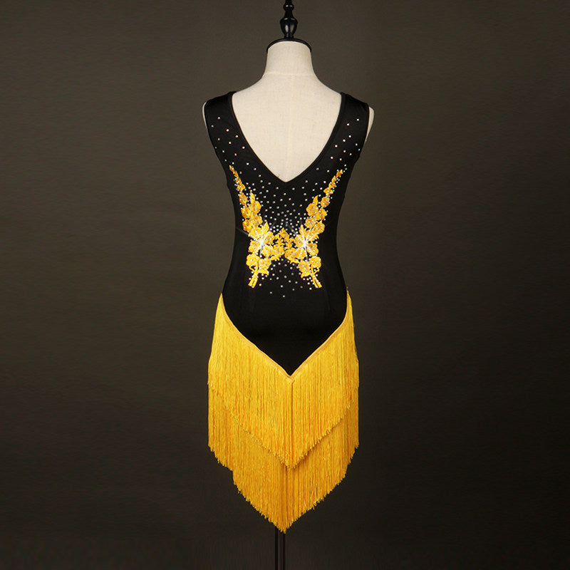 Black latin dance dress showing the gold appliques and rhinestones across the V neckline