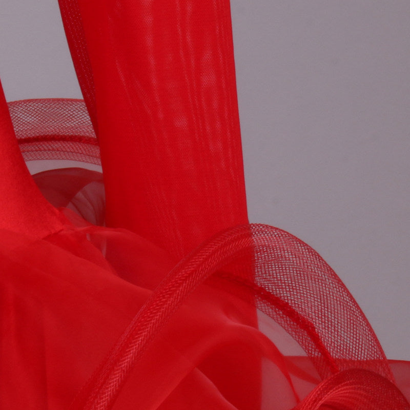 Close view of the red curled organza ruffle layers at the hem