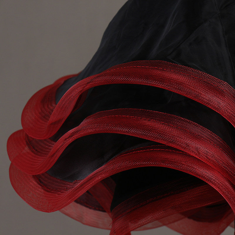 Close view of the red and black organza curls at the hem