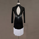 Black latin dance dress rear view with the oval opening above the white fringe hem