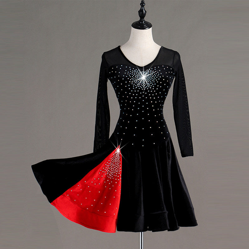 Black latin dance dress with red godet panels flaring from the skirt seams