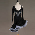 Black latin dance dress angled view showing the stoned mesh sleeves and grey ruffle edge