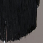Close view of the dense black tassel fringe on the skirt