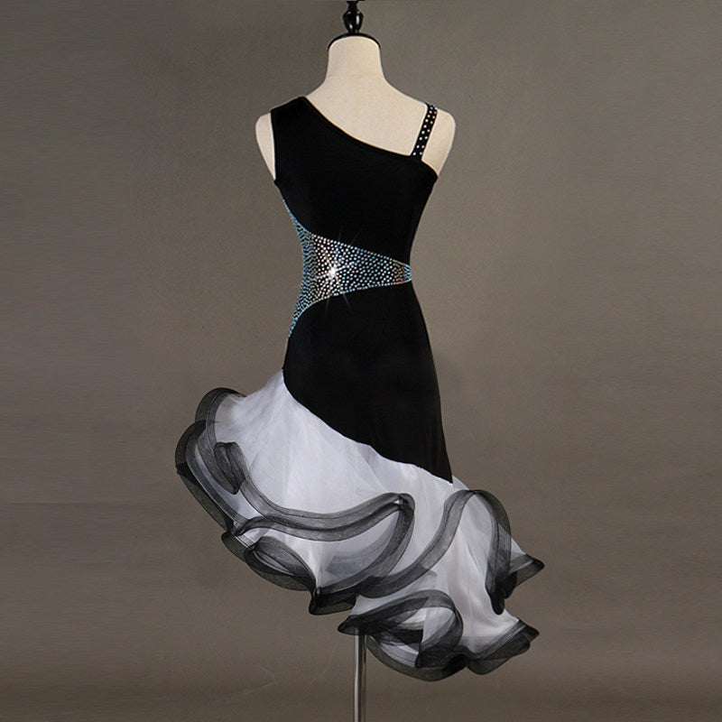 Black one shoulder latin dance dress angled view showing the grey and white organza curls