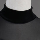 Close view of the sheer mesh high neck collar on velvet