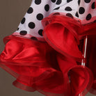 Close view of the red curled organza ruffle layers on polka dot