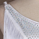 Close view of the stoned strap edge above the white fringe