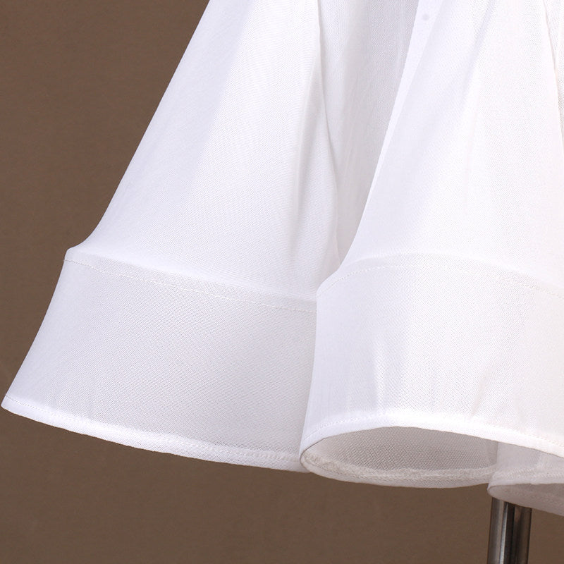 Close view of the white flared skirt hem