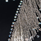 Close view of the silver bugle bead fringe and rhinestone edging