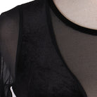 Close view of the sheer panel meeting the velvet bodice