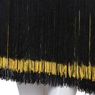 Close view of the black fringe banded with gold at the hem