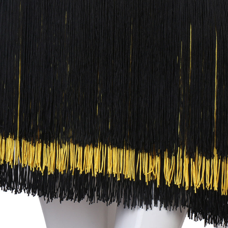 Close view of the black fringe banded with gold at the hem