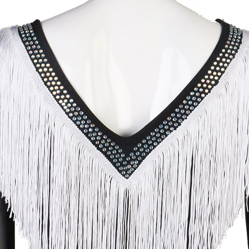 Close view of the studded V neckline above the white fringe