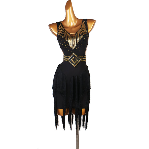 Black latin dance dress with gold bead fringe and studded belt over a ragged hem