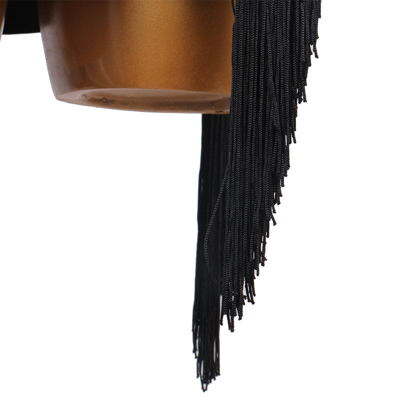 Close view of the ragged tassel fringe at the hem