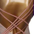 Close view of the crossed strap back on the nude panel