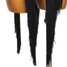 Close view of the ragged black tassel fringe at the hem