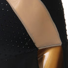 Close view of the nude mesh panel meeting the stoned black fabric