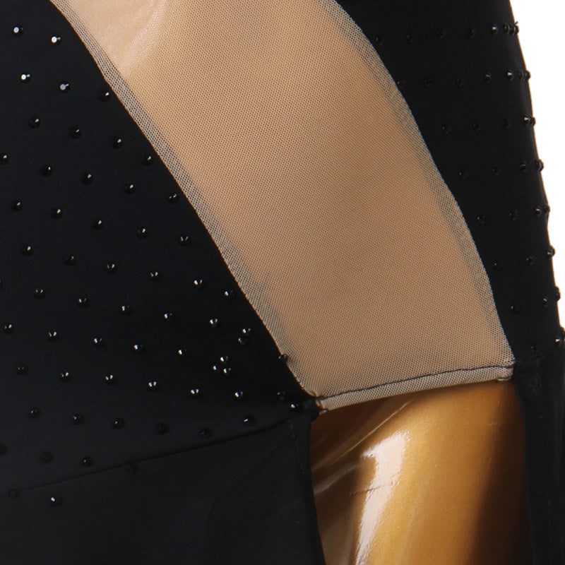 Close view of the nude mesh panel meeting the stoned black fabric