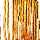 Close view of the gold bugle fringe hanging from the sheer mesh yoke