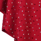 Close view of the crystals set densely across the red skirt