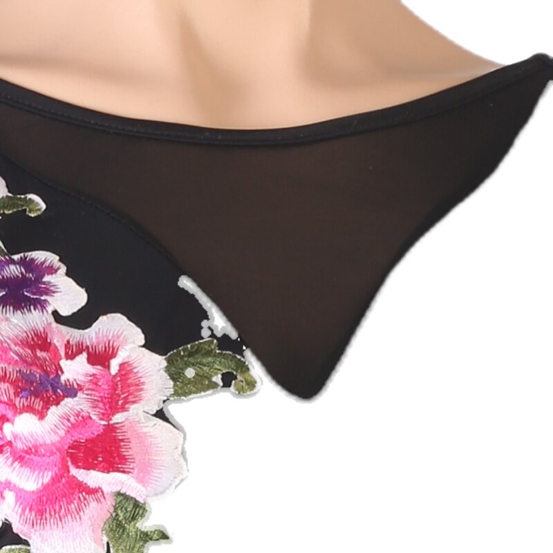 Close view of the raised peony embroidery against the mesh yoke