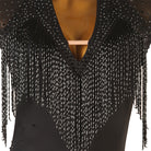Close view of the bead fringe hanging over the plunging neckline