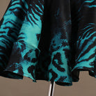 Close view of the turquoise animal print on the skirt