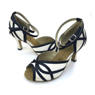 pair of white satin ballroom practice shoes for women with black looped trim, peep toe and flared heels