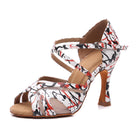 White salsa dance shoe for women with a red and black splatter print, open toe latin heel with mesh inserts and crossover ankle strap
